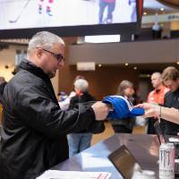 An alumnus receiving his Red Wings GVSU hat at the Detroit Red Wings GVSU Night